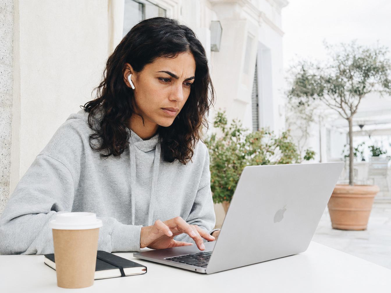 Femme travaillant sur ordinateur portable en terrasse